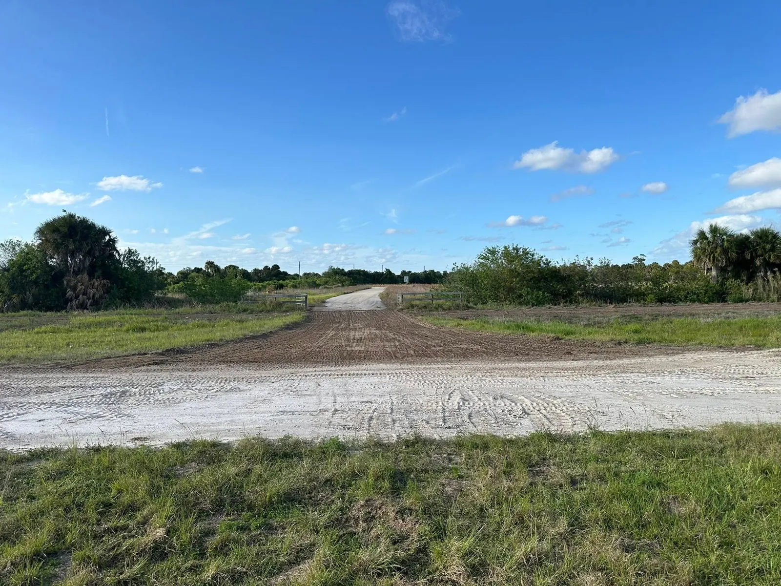 Driveway base surface beside an open field